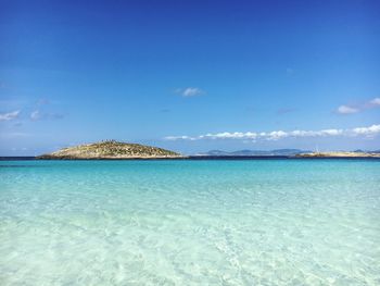 Scenic view of sea against blue sky