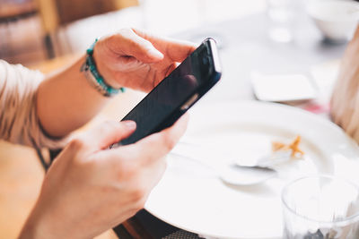 Close-up of hand holding mobile phone