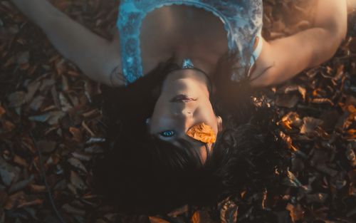 High angle view of woman lying on land
