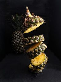 Close-up of fresh fruits on table against black background