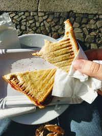 Midsection of man eating sandwich