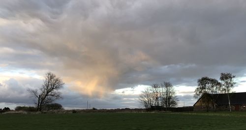 Scenic view of field against rainbow in sky