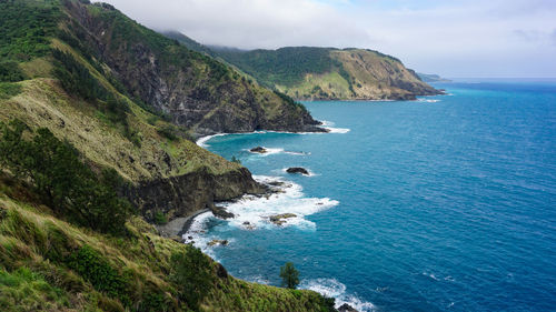 Scenic view of sea and mountains against sky