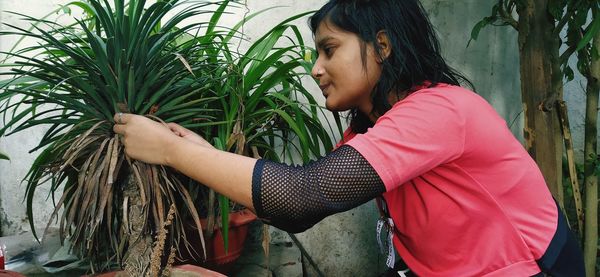 Side view of woman against plants