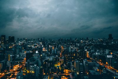 Aerial view of city lit up at night