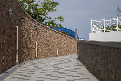 Footpath by wall against building