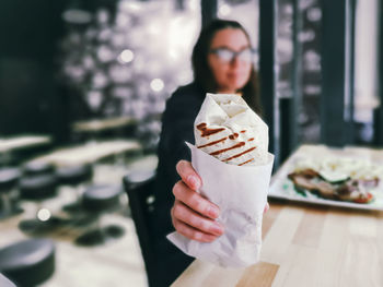 Midsection of woman holding ice cream