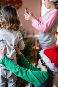 High angle view of mother carrying daughter at home