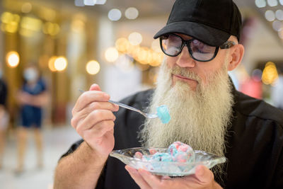 Portrait of man holding ice cream cone