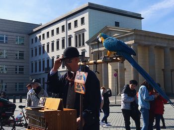 People standing on street against buildings in city