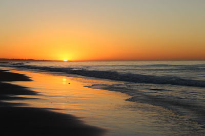 Scenic view of sea against clear sky during sunset