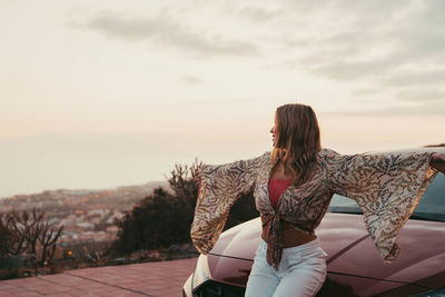 Rear view of woman sitting on bench