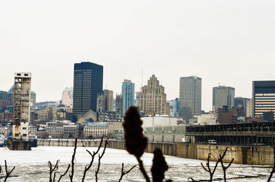 City buildings against clear sky during winter