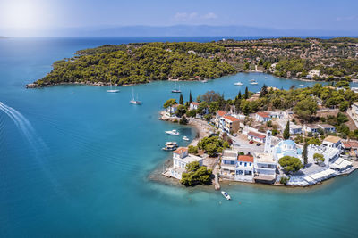 High angle view of townscape by sea against sky