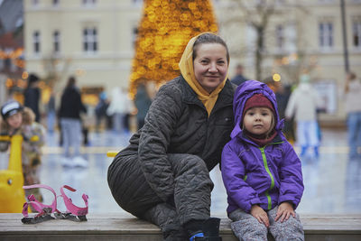 Portrait of smiling young woman in city