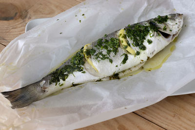 High angle view of fish in plate on table