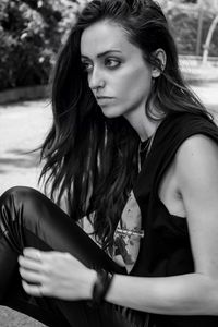 Portrait of beautiful young woman sitting outdoors