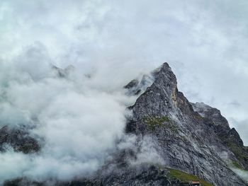 Low angle view of rocky mountain against sky