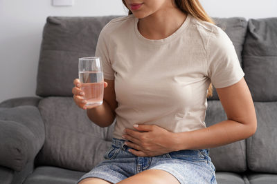 Midsection of woman using mobile phone