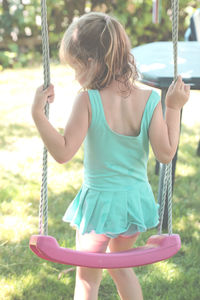 Girl playing on swing