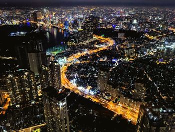 High angle view of city lit up at night