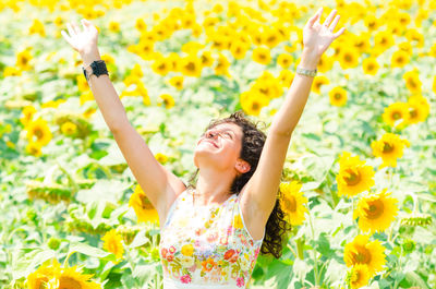 Happy young woman with yellow flowers