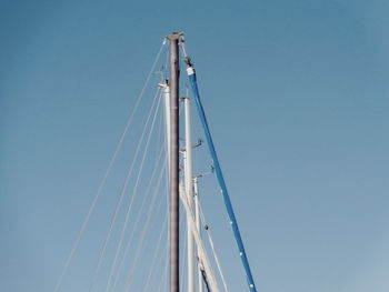 Low angle view of sailboat against clear blue sky