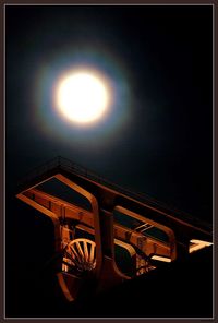 Low angle view of illuminated street against sky