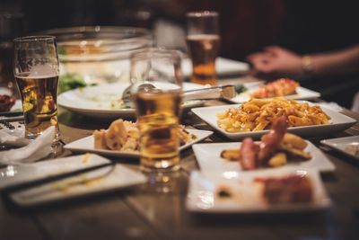 Close-up of food and beer on table in restaurant