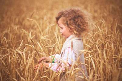 Side view of a girl standing on field