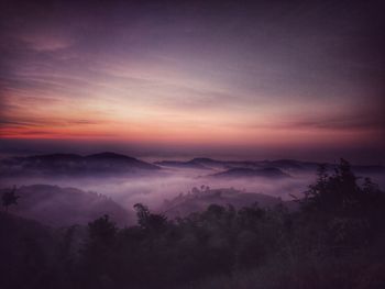 Scenic view of silhouette mountains against sky during sunset