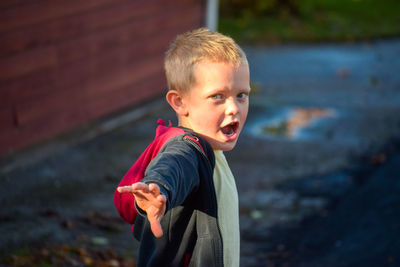 Portrait of boy standing outdoors