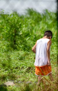 Rear view of man standing on field