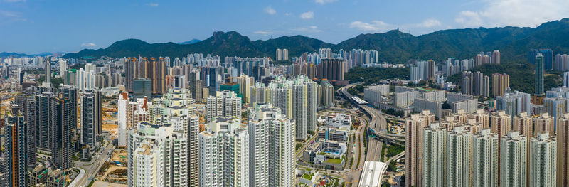 Aerial view of modern buildings in city against sky