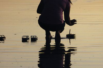 Low section of people standing on puddle