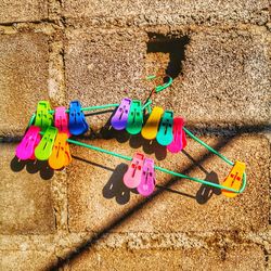 Close-up of multi colored clothespins hanging on clothesline