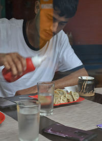 Man eating momos at restaurant