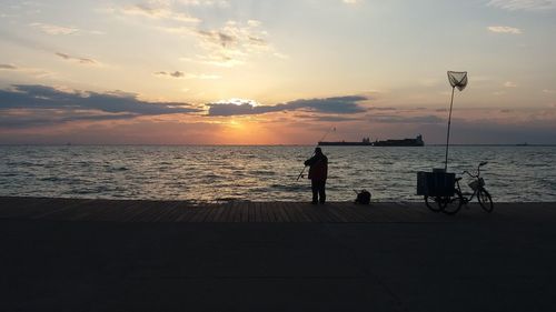 People enjoying in sea during sunset
