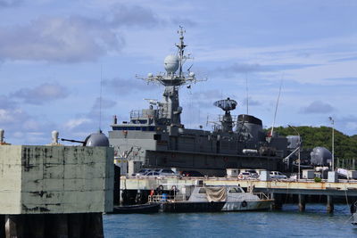 Commercial dock by sea against sky