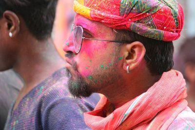 Portrait of young man with multi colored umbrella