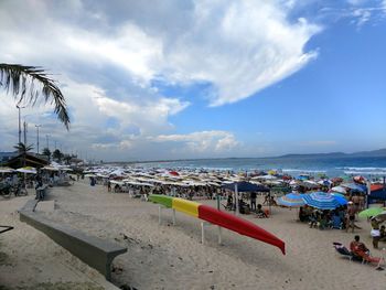 View of beach against cloudy sky