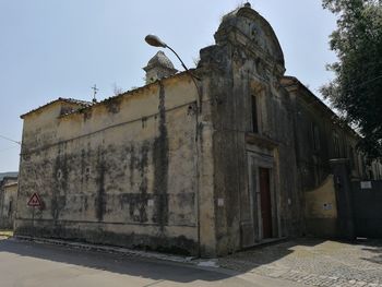 Low angle view of old abandoned building against sky