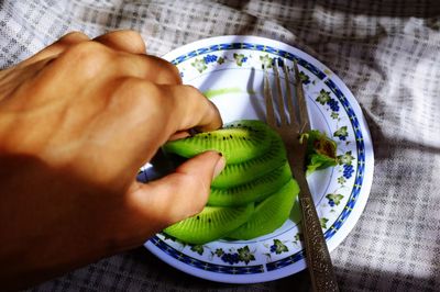 High angle view of man preparing food on bed at home