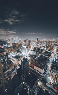 High angle view of illuminated buildings against sky at night