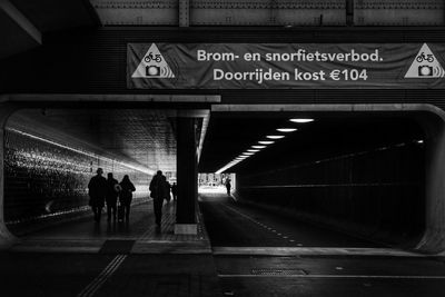 People walking on illuminated subway station