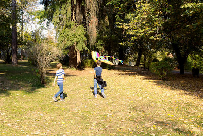 Rear view of people walking in park