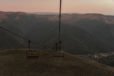 Overhead cable car against mountains during sunset