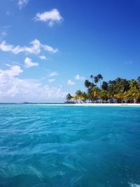 Scenic view of sea and island against sky