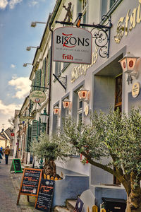 Information sign against sky