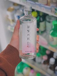 Close-up of human hand holding bottle